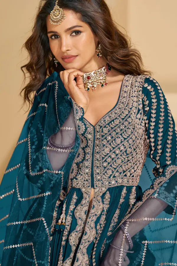 Detailed close-up of the front bodice embroidery on the vibrant teal blue chinon silk ethnic tunic.