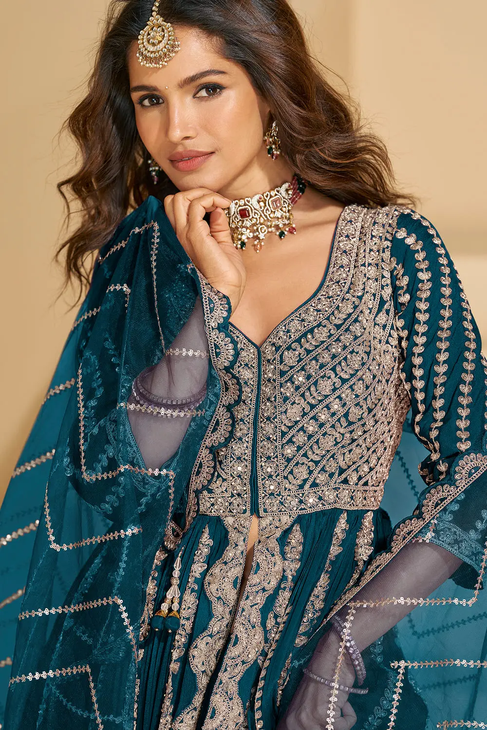 Detailed close-up of the front bodice embroidery on the vibrant teal blue chinon silk ethnic tunic.