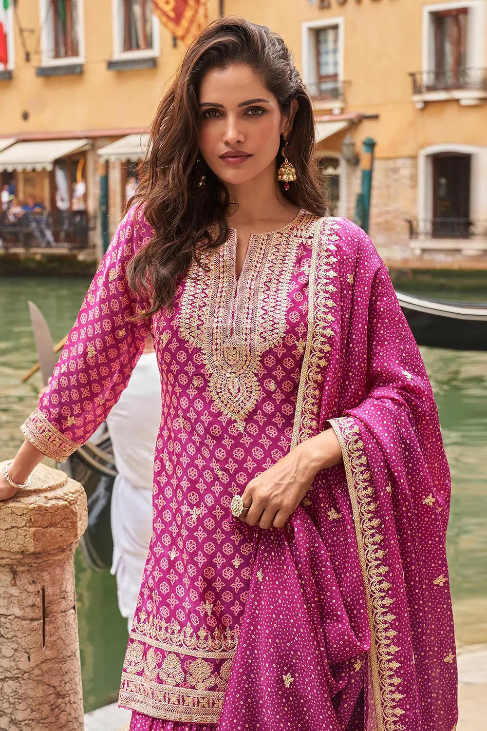 Close up showing digital print pattern and embroidery thread layered on magenta pink real silk kurta top