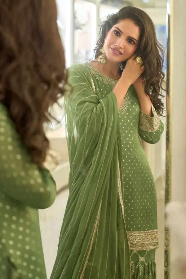 Close up of shimmer woven jacquard and embroidery on green sharara kurta top surface