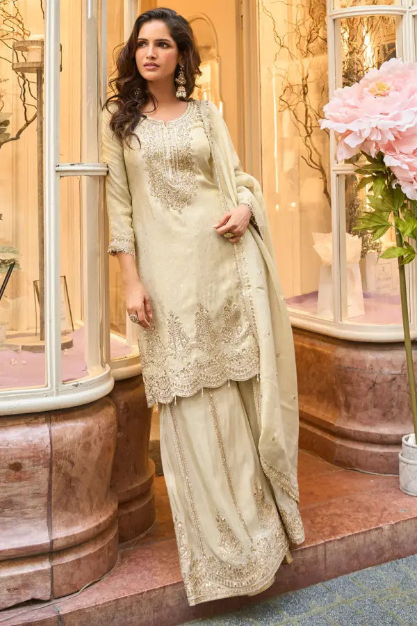 Off white jacquard silk sharara set with heavy embroidered top and dupatta by Khaish