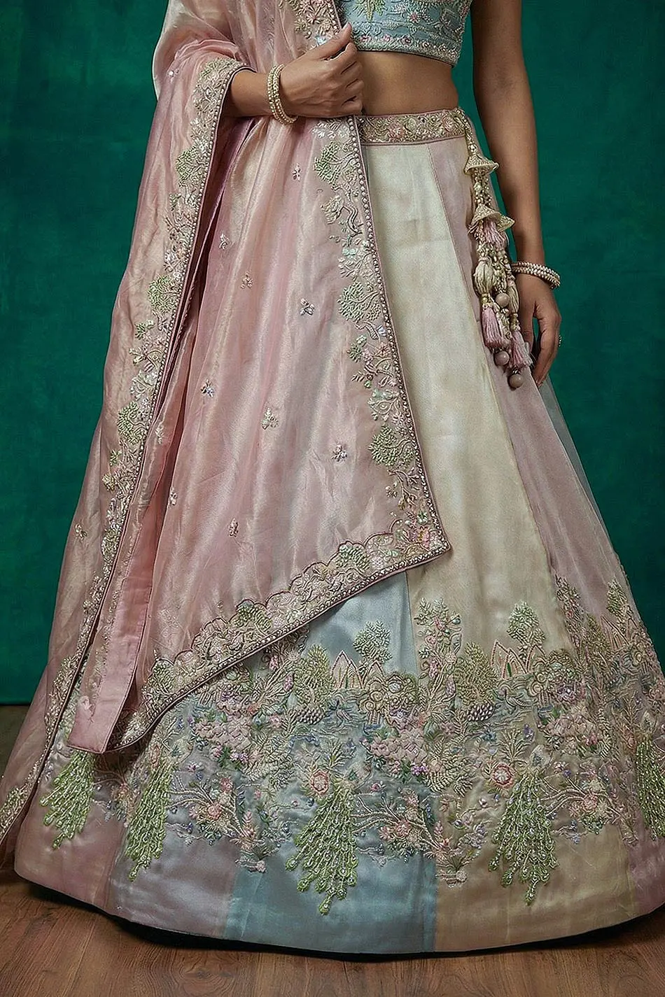 Hanging beads latkan along the taping border at the lehenga hem