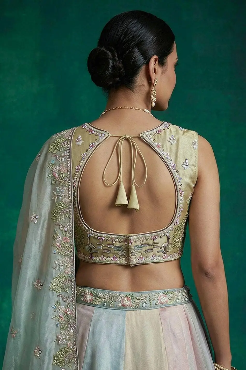 Green blouse photographed from behind, showing sweetheart neckline and sleeve work