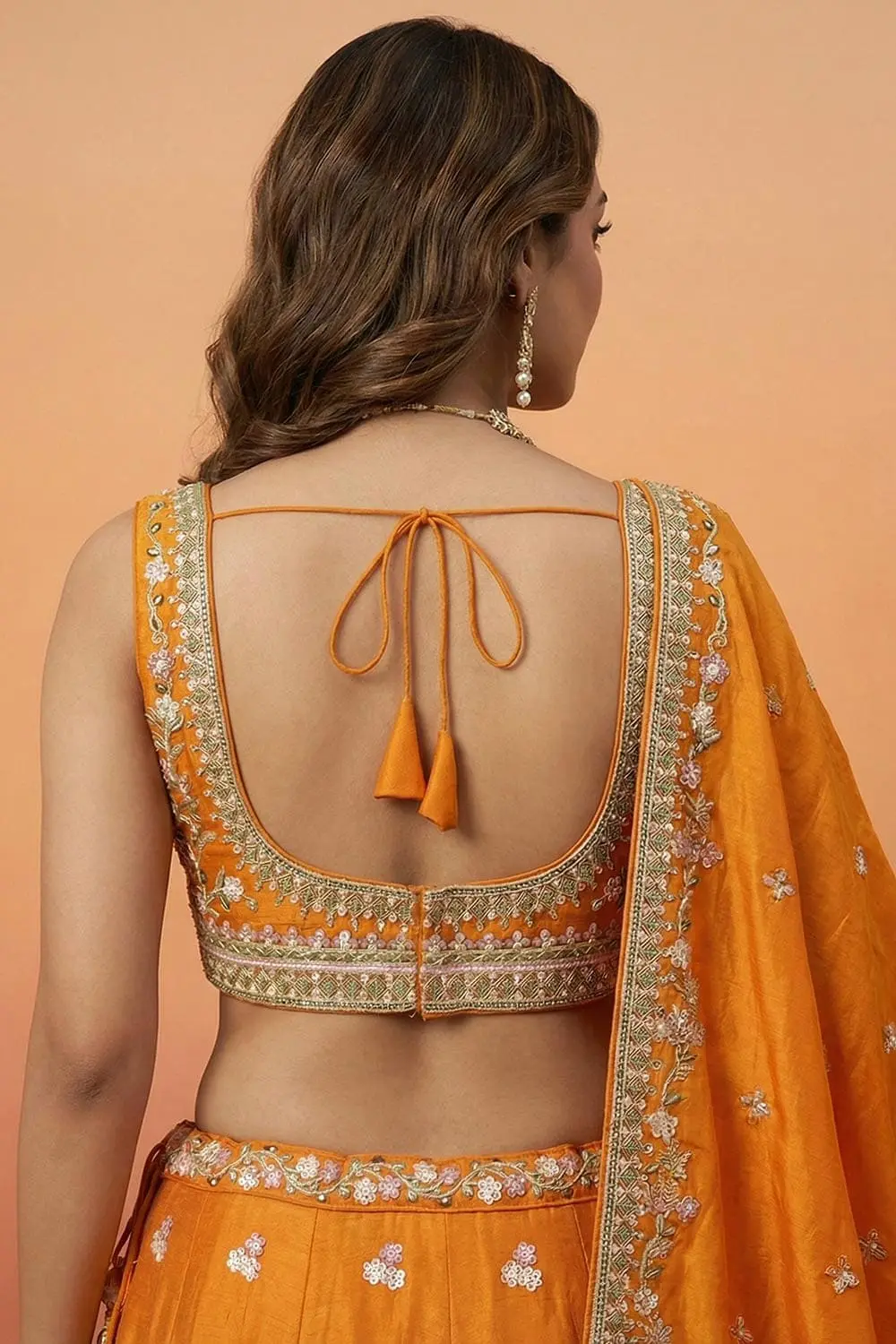 Back of the orange blouse — V-neck line and thread embroidery across the shoulders