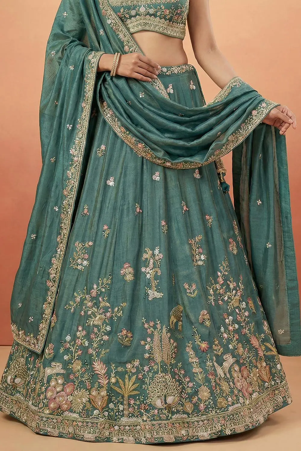 Full skirt volume in teal tissue, buckram holding the hem open