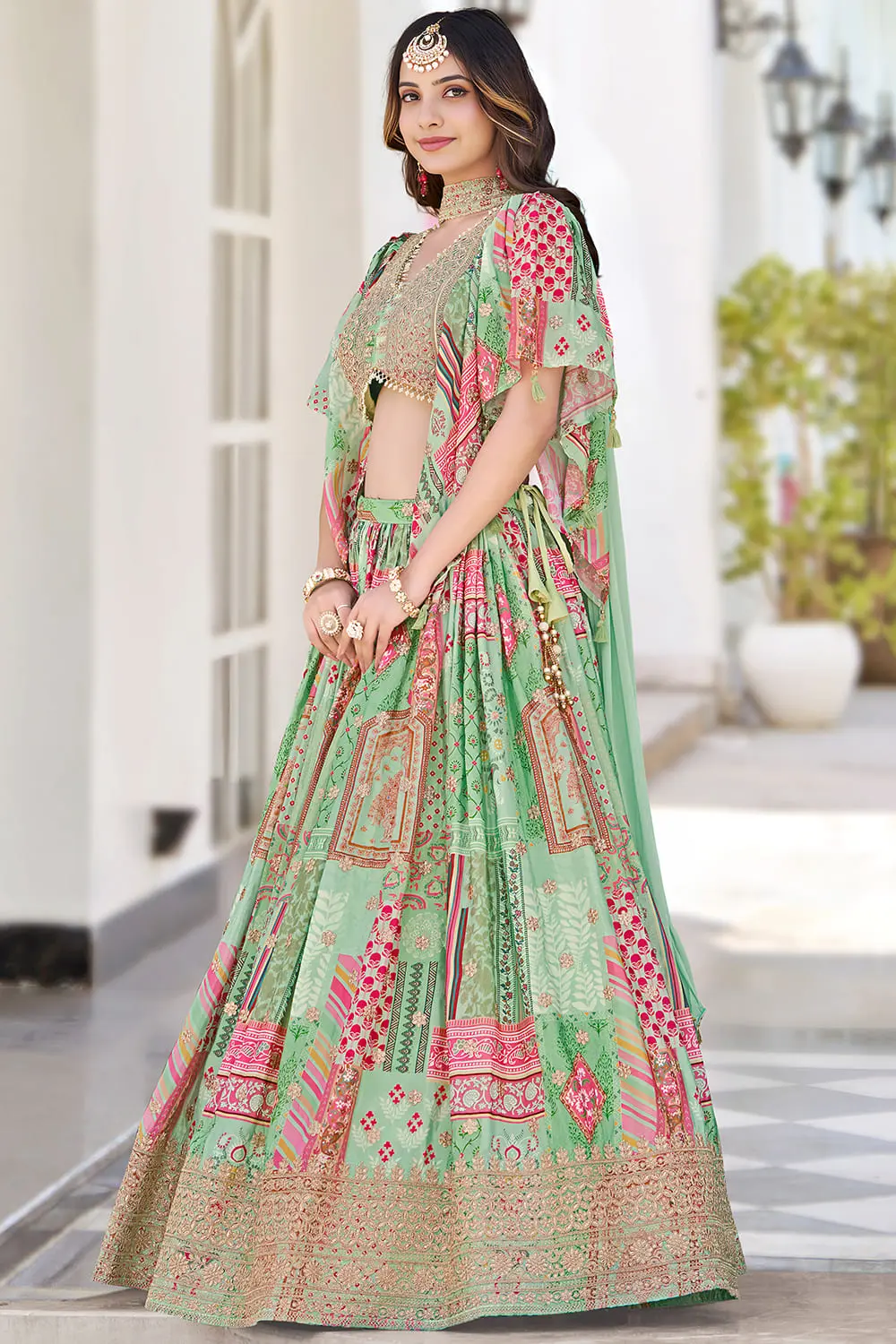 Side angle view of green lehenga flare with chiffon dupatta draped