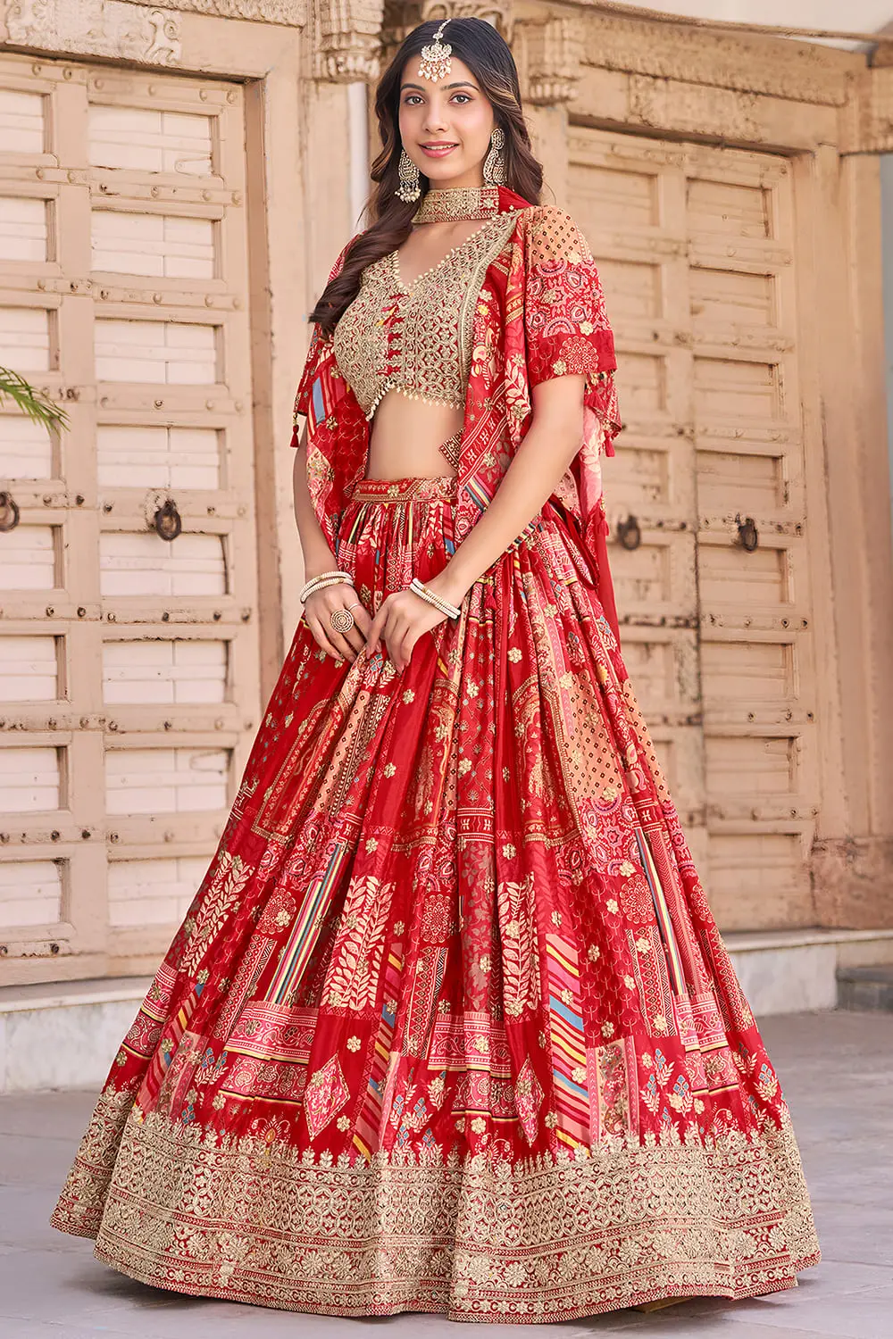 Side profile mid-step, red lehenga's flare and chiffon dupatta both in motion