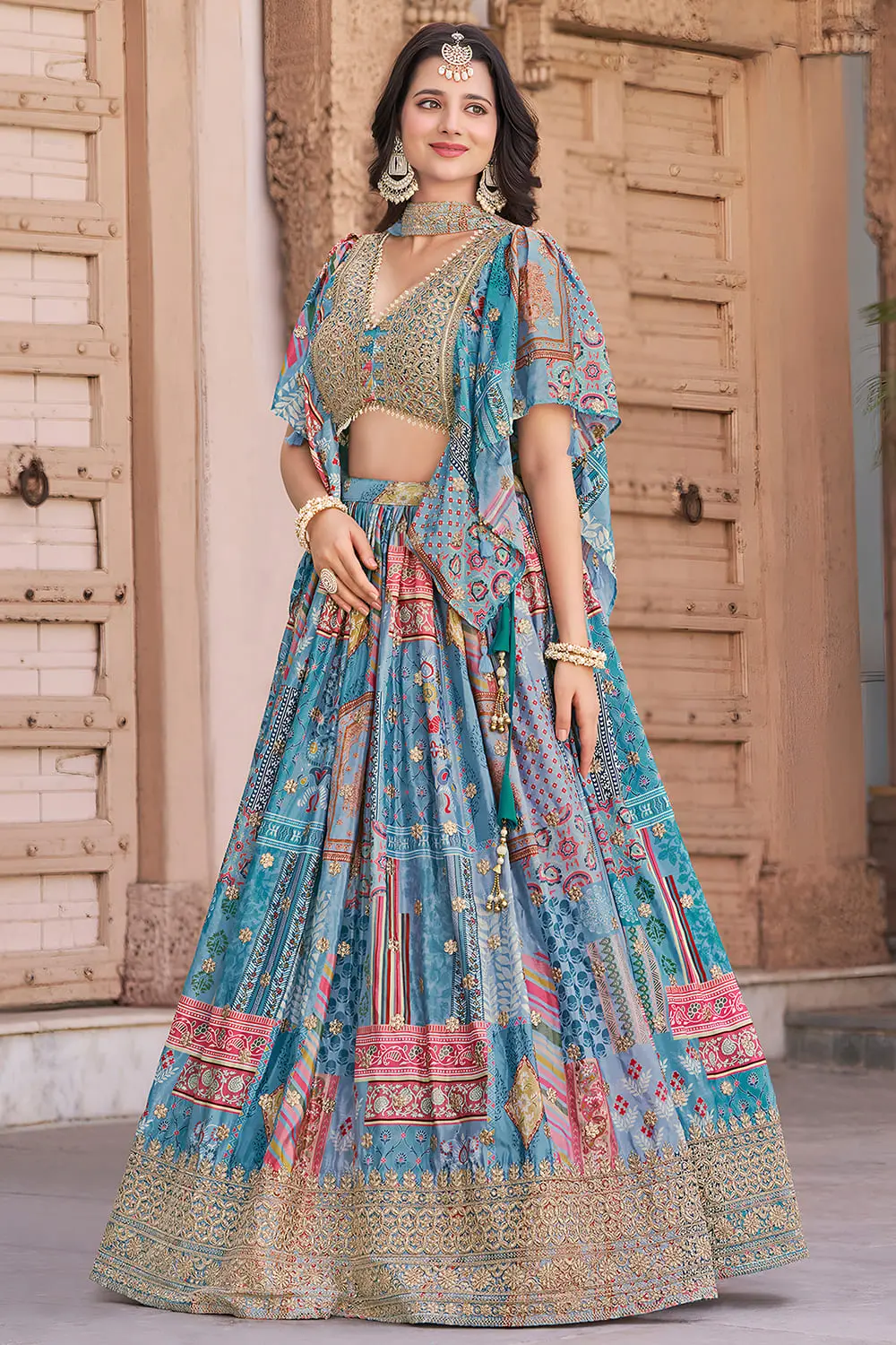 Sky blue lehenga in profile, dupatta lifting as the flare moves