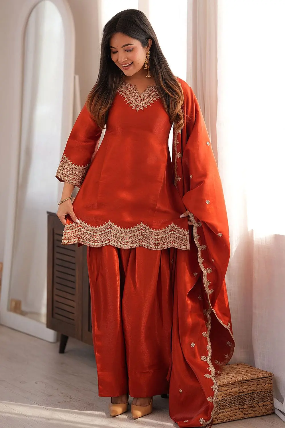 Model in bright orange pakistani salwar kameez