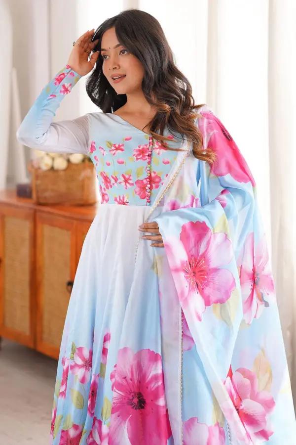 Close up of gota patti lace border on light blue organza silk dupatta alongside floral anarkali