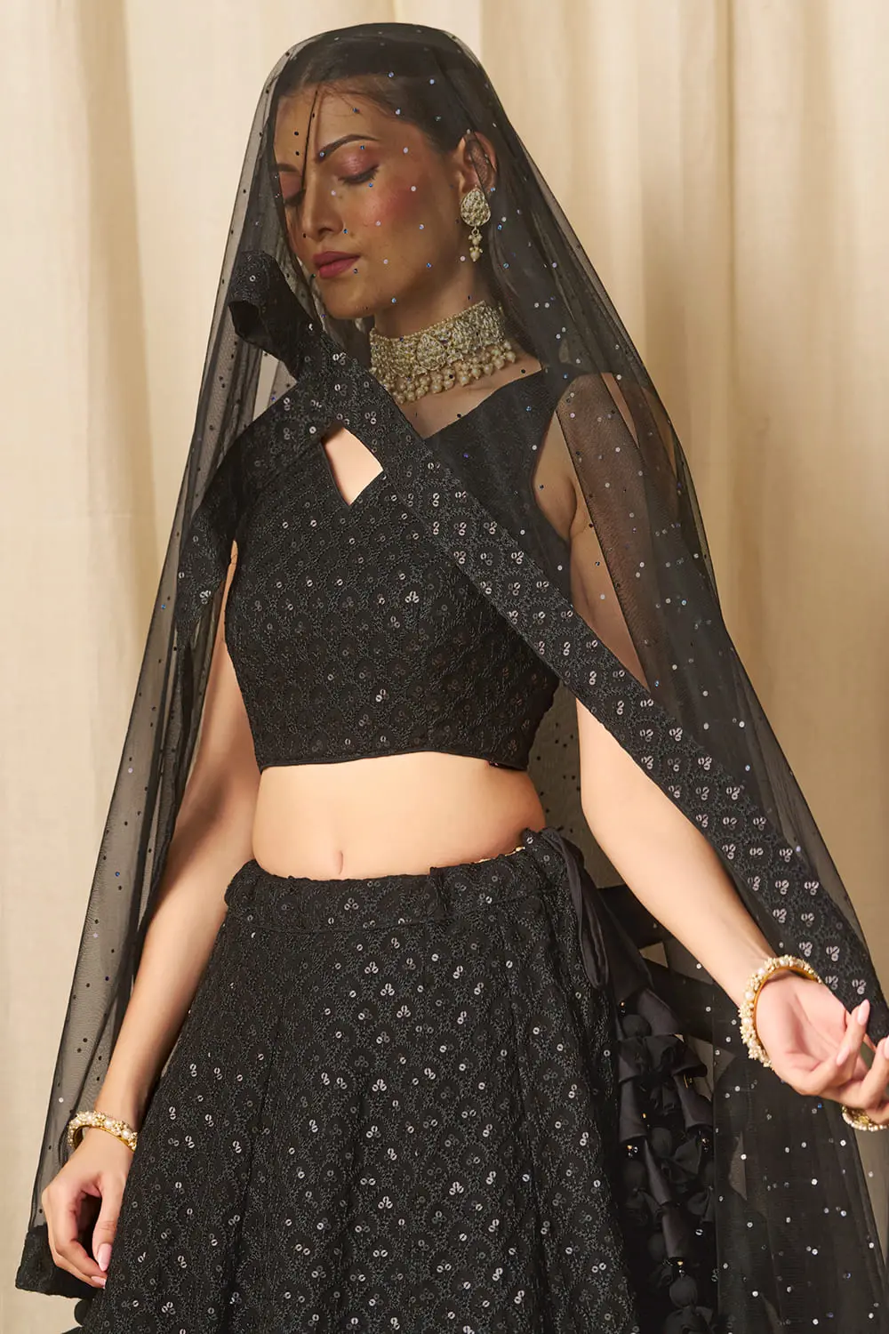Close up of black georgette lehenga blouse with sequin work