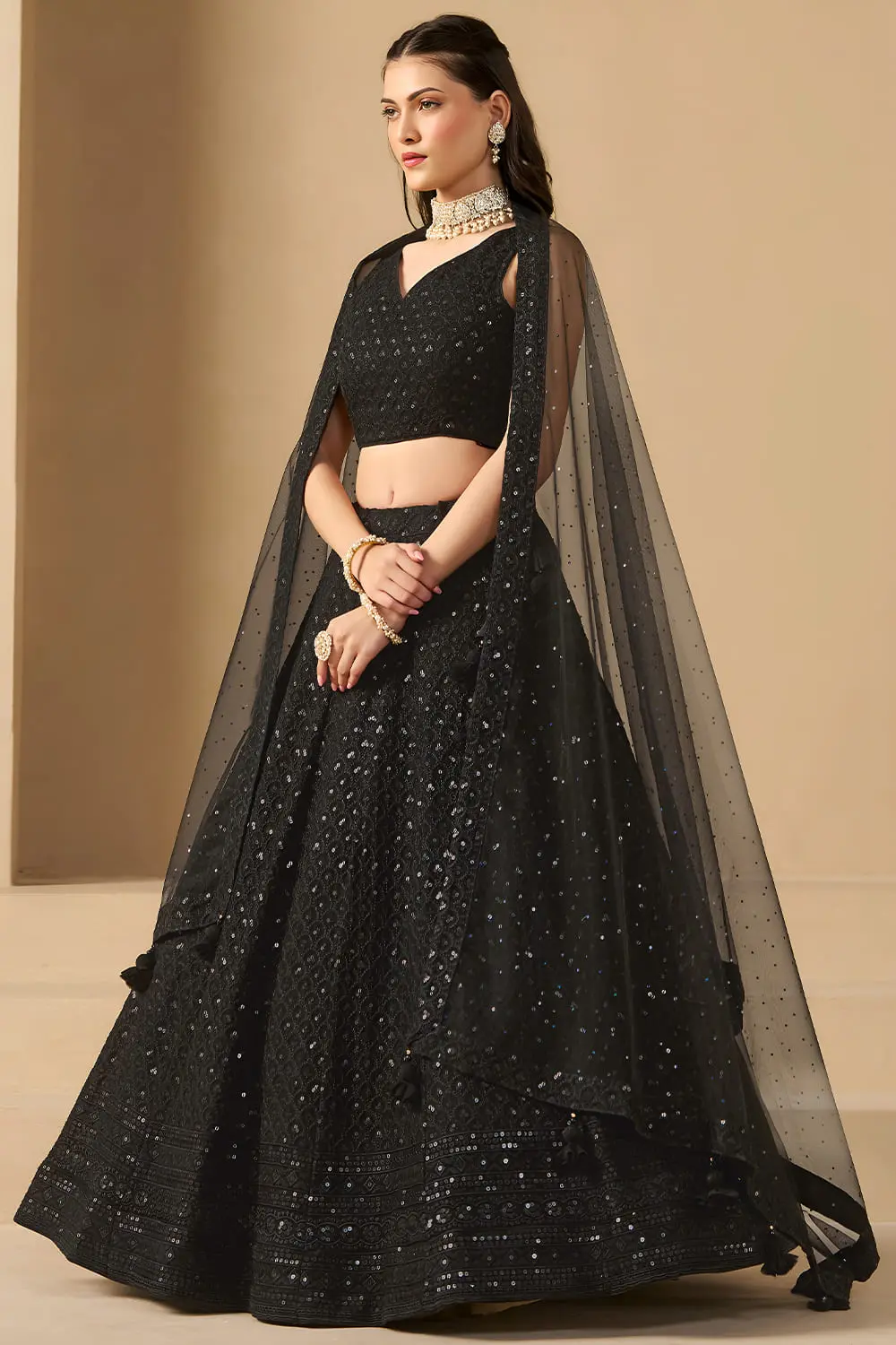 Side angle view of black sequin georgette lehenga set