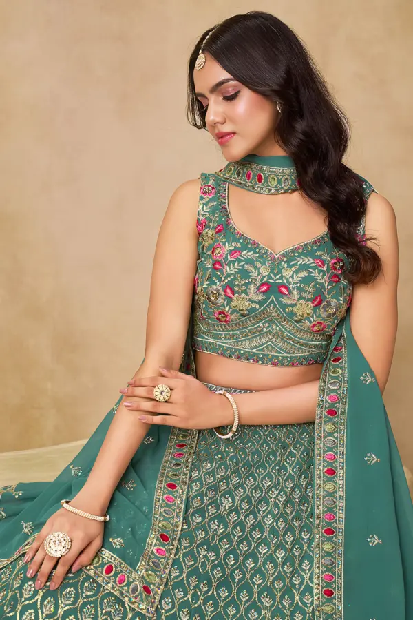 Close up of sequins and thread embroidery on blue georgette lehenga