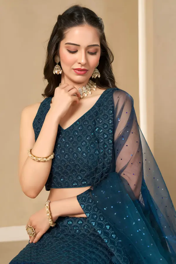 Close up of sequins and thread embroidered work on blue georgette blouse