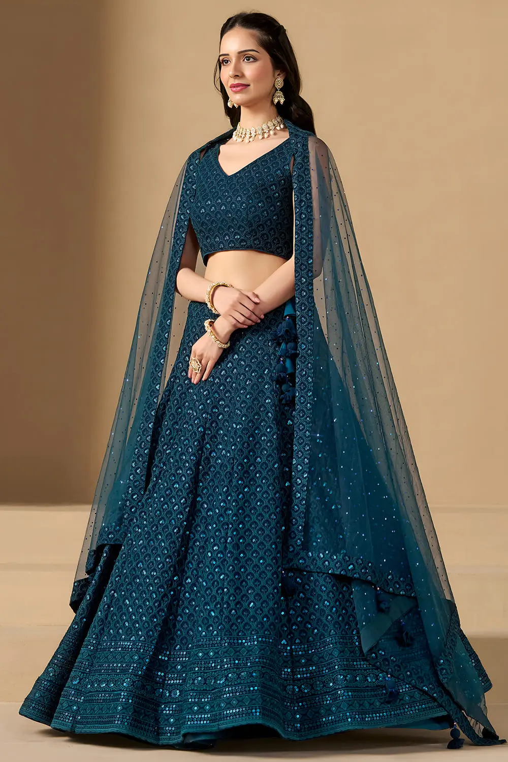 Right side profile showcasing the flare of the blue lehenga dress