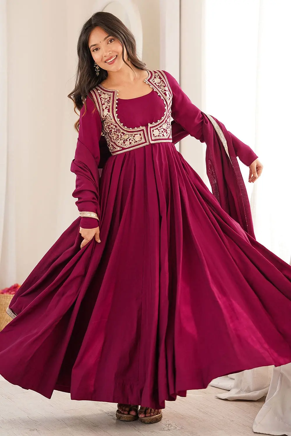 Woman wearing heavy pure Roman Silk Chanderi ethnic suit in Rani Pink
