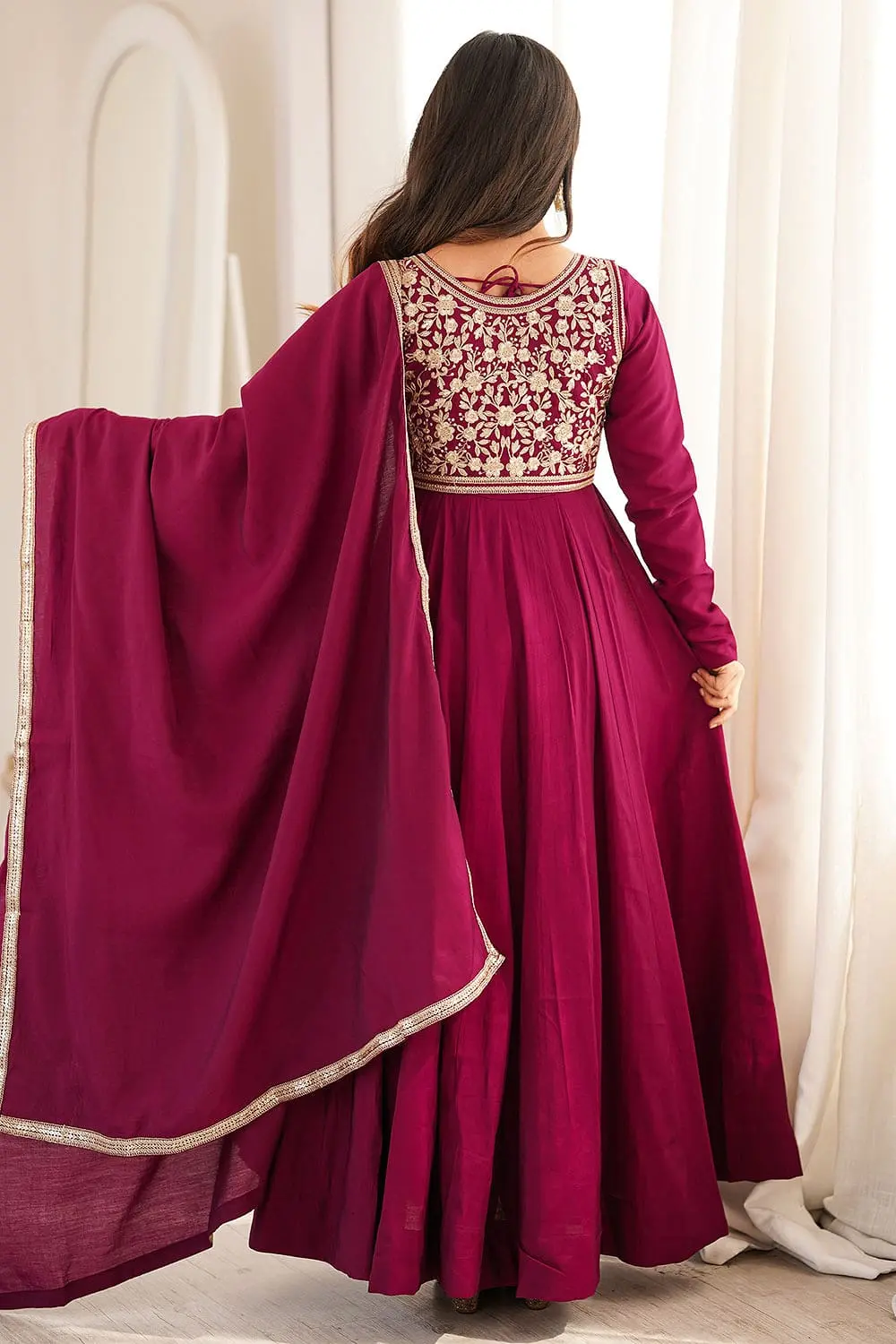 Back view of the Rani pink Anarkali gown showing flare, drape, and jacket fit