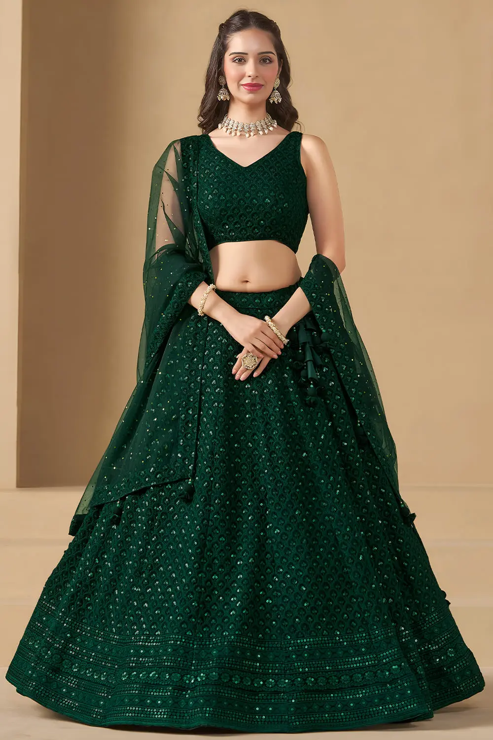Woman wearing a vibrant green georgette lehenga dress for wedding festivities