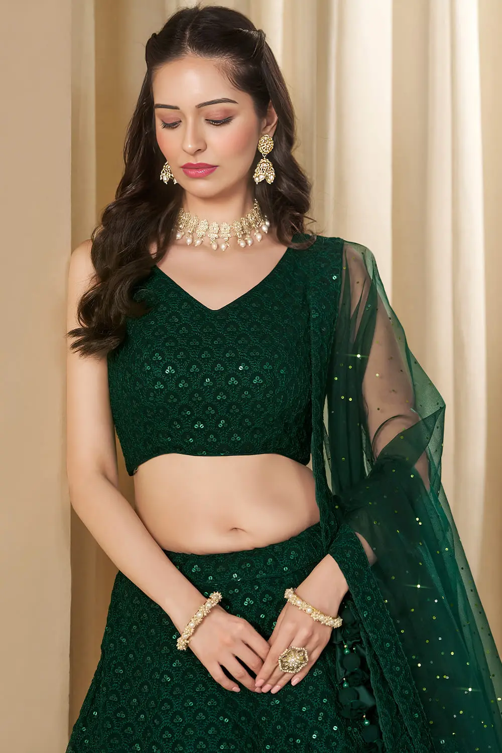 Close up of intricate thread work and precise sleeve construction on the green blouse