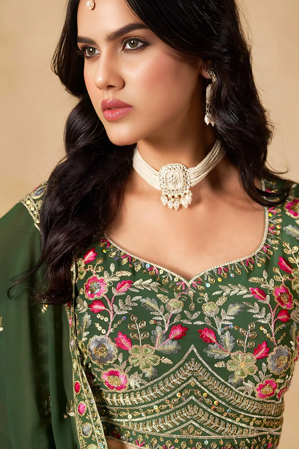 Close up of green georgette lehenga blouse with sequin work