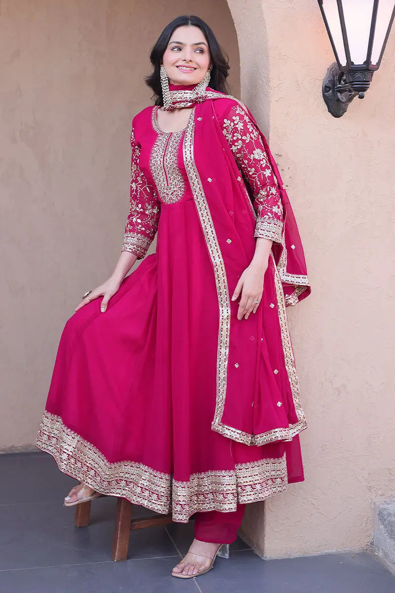 Woman wearing a pink Anarkali suit with sequins work dupatta