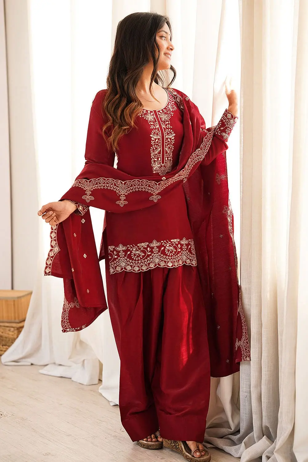 Model wearing maroon designer silk kurta set