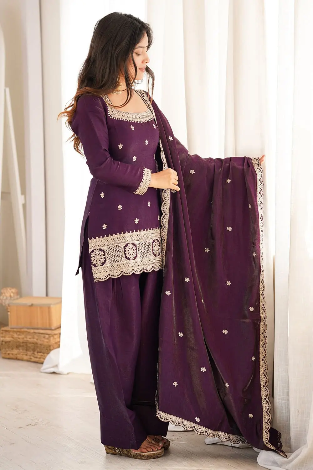 Model wearing deep purple silk salwar kameez