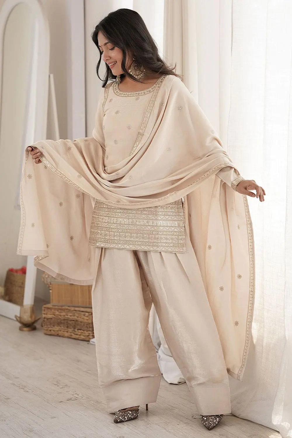 Model showcasing off white silk salwar suit