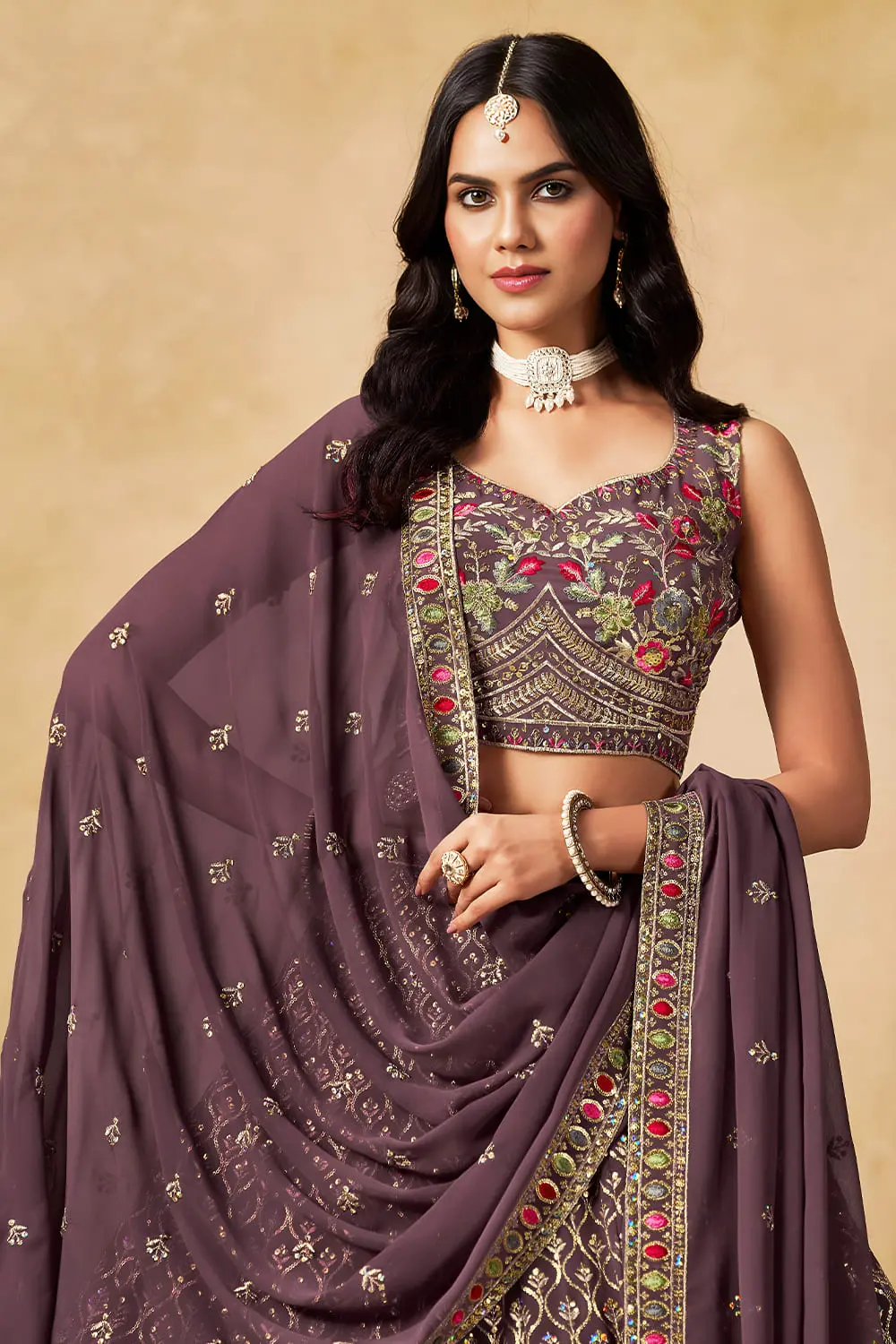 Close up of sequins and thread embroidery on purple georgette lehenga