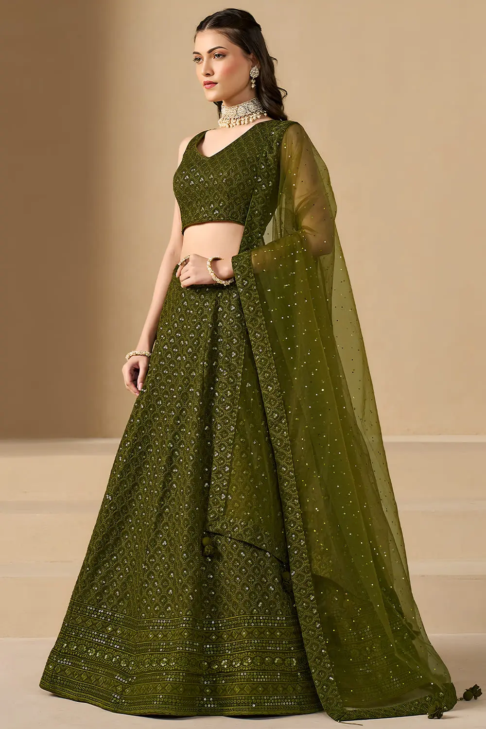 Right profile view highlighting the graceful flare of the olive green skirt