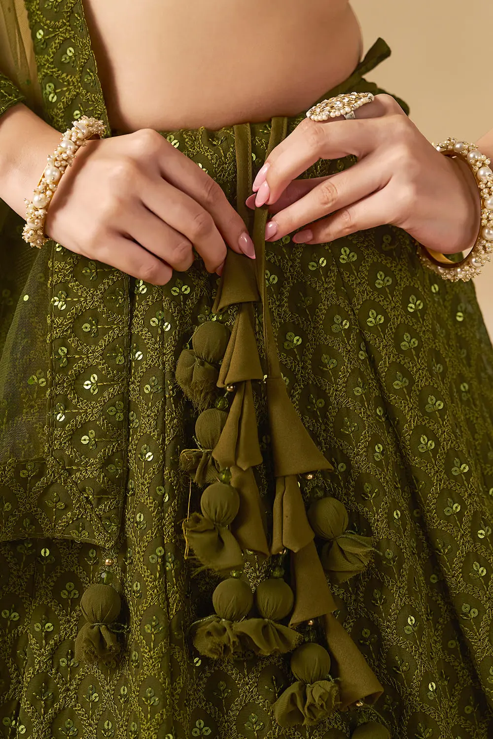 Detailed view of carefully balanced side dori and tassel placement on the waistline