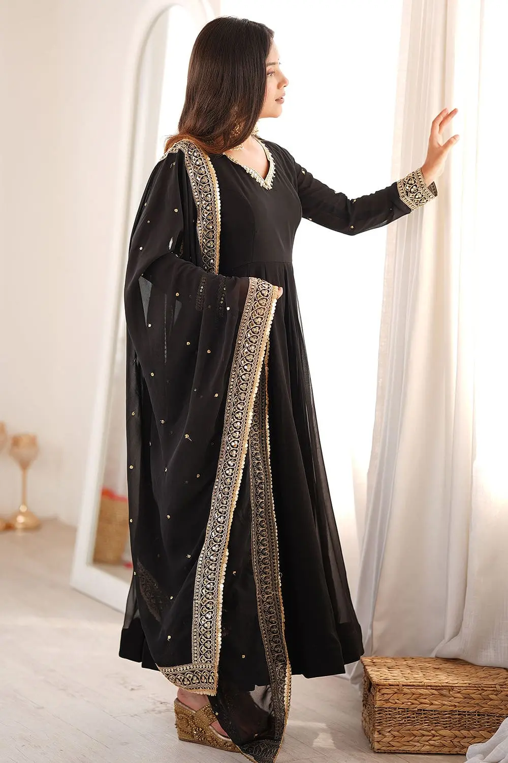 Full-length showcase highlighting the flare of the black georgette anarkali set.