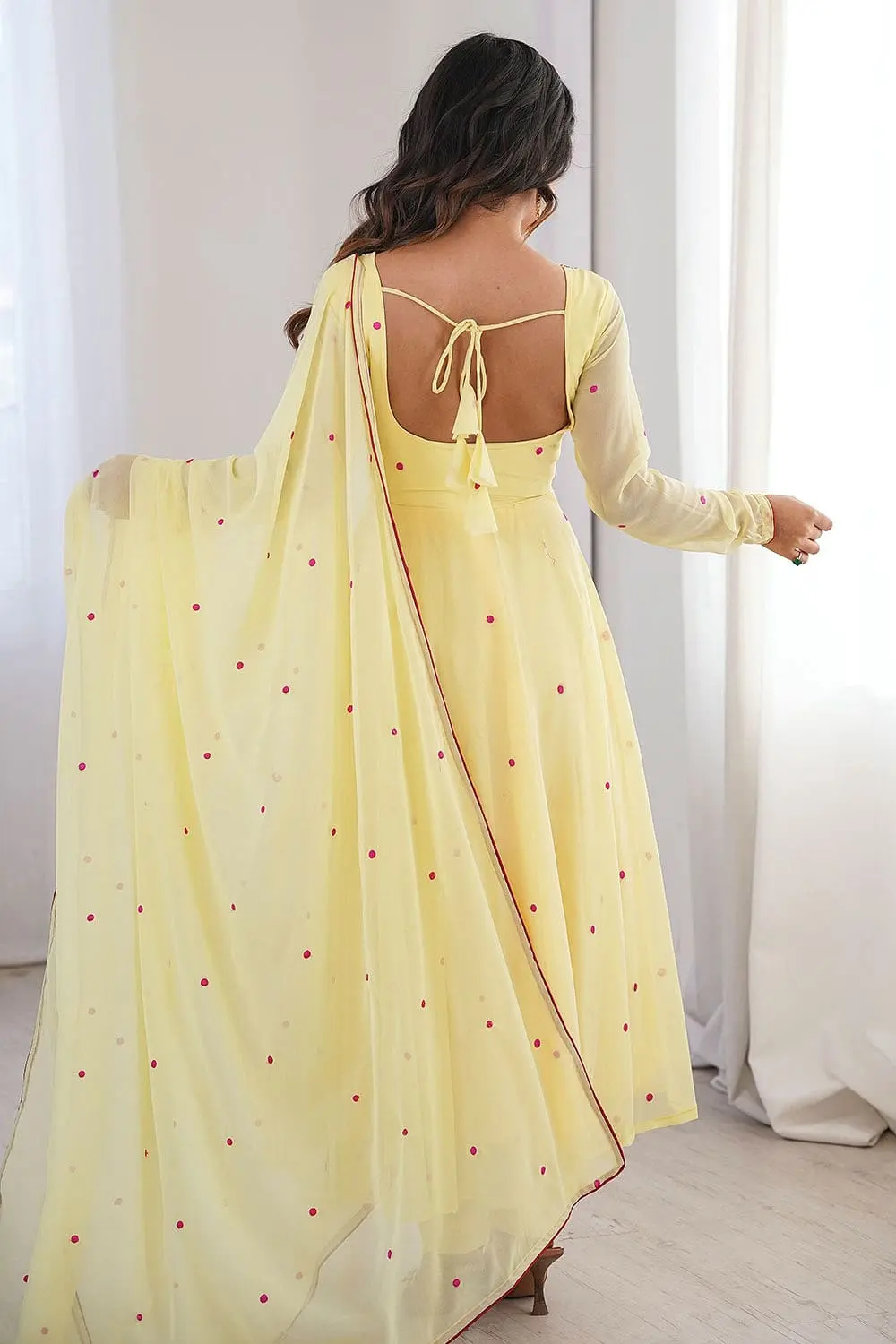 Back view of yellow embroidered anarkali set showing full back and dupatta fall