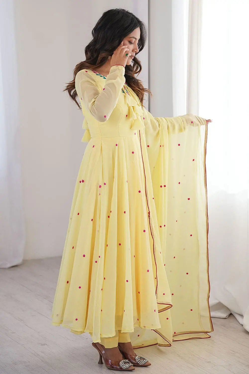 Yellow faux georgette anarkali set third front angle showing thread embroidery across the anarkali