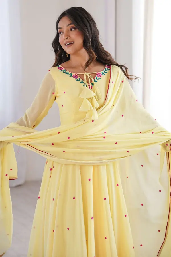 Close up of thread embroidery and designer detailing on yellow faux georgette anarkali