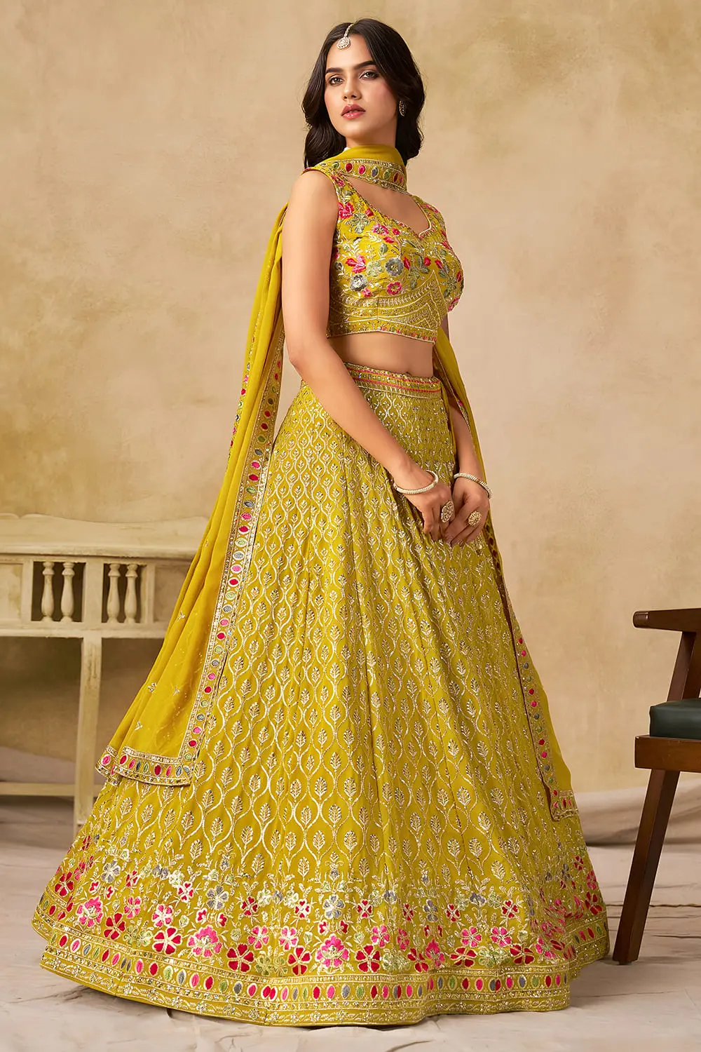 Side angle view of yellow georgette lehenga with dupatta draped