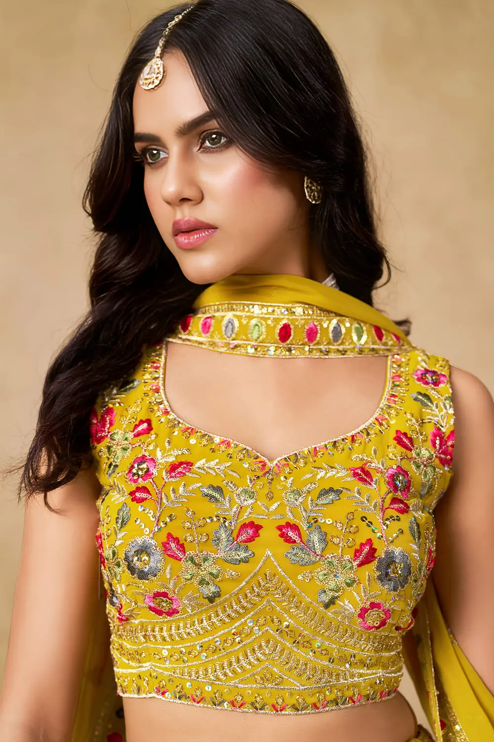 Close up of yellow georgette lehenga blouse with sequin work