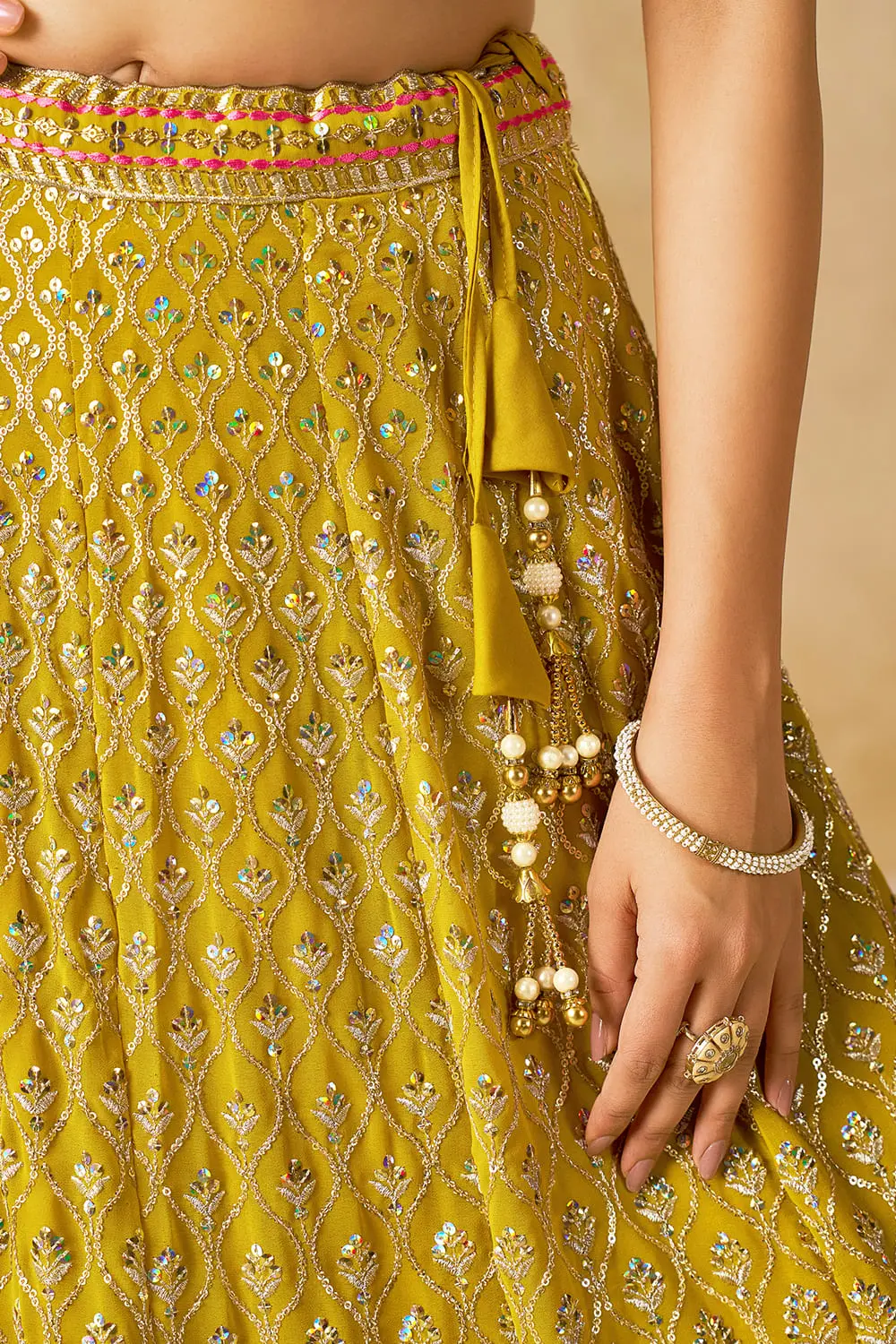 Tassel detail on yellow georgette lehenga with sequin work